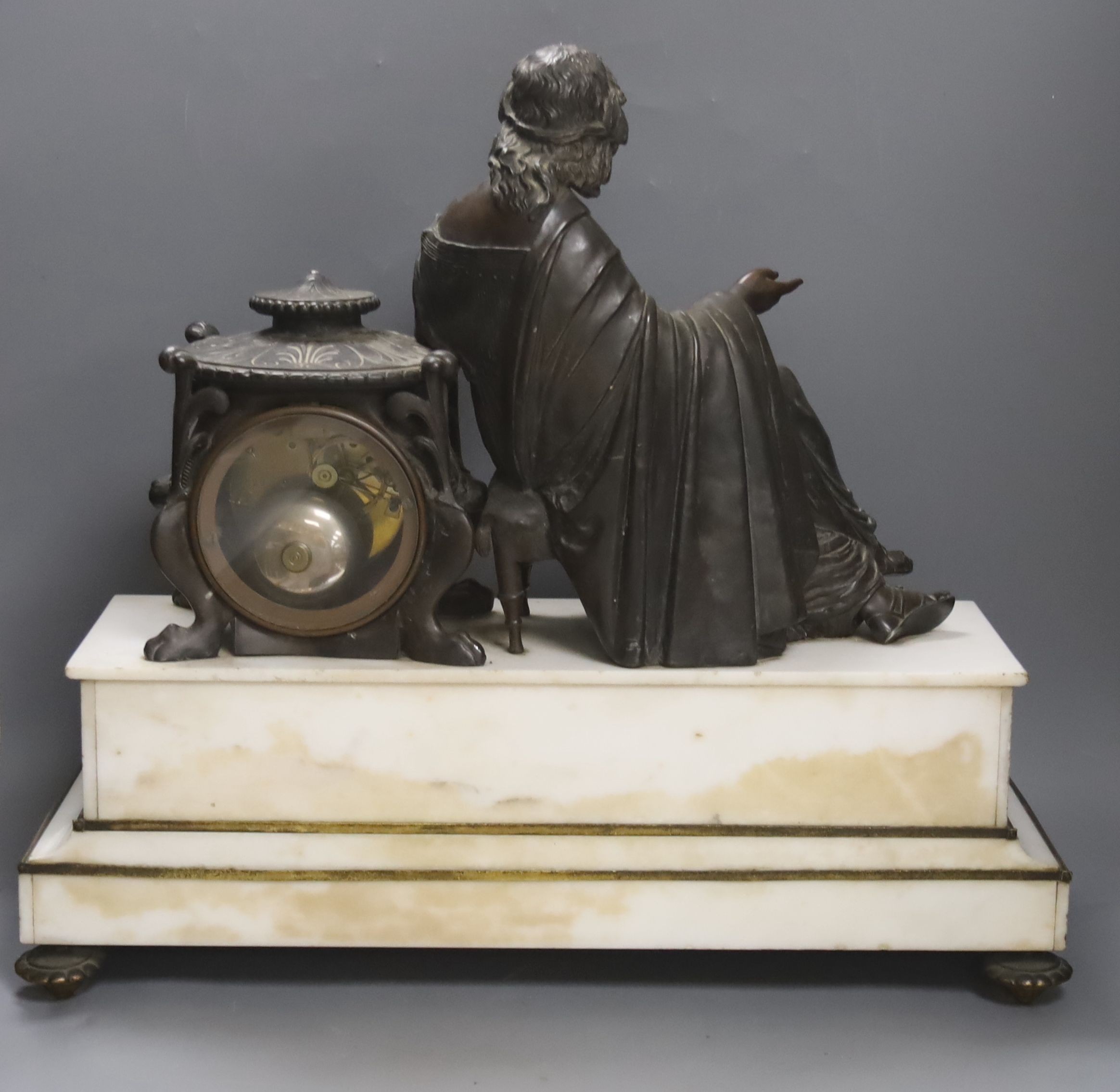 A French marble and bronzed metal figural mantel clock. 49cm